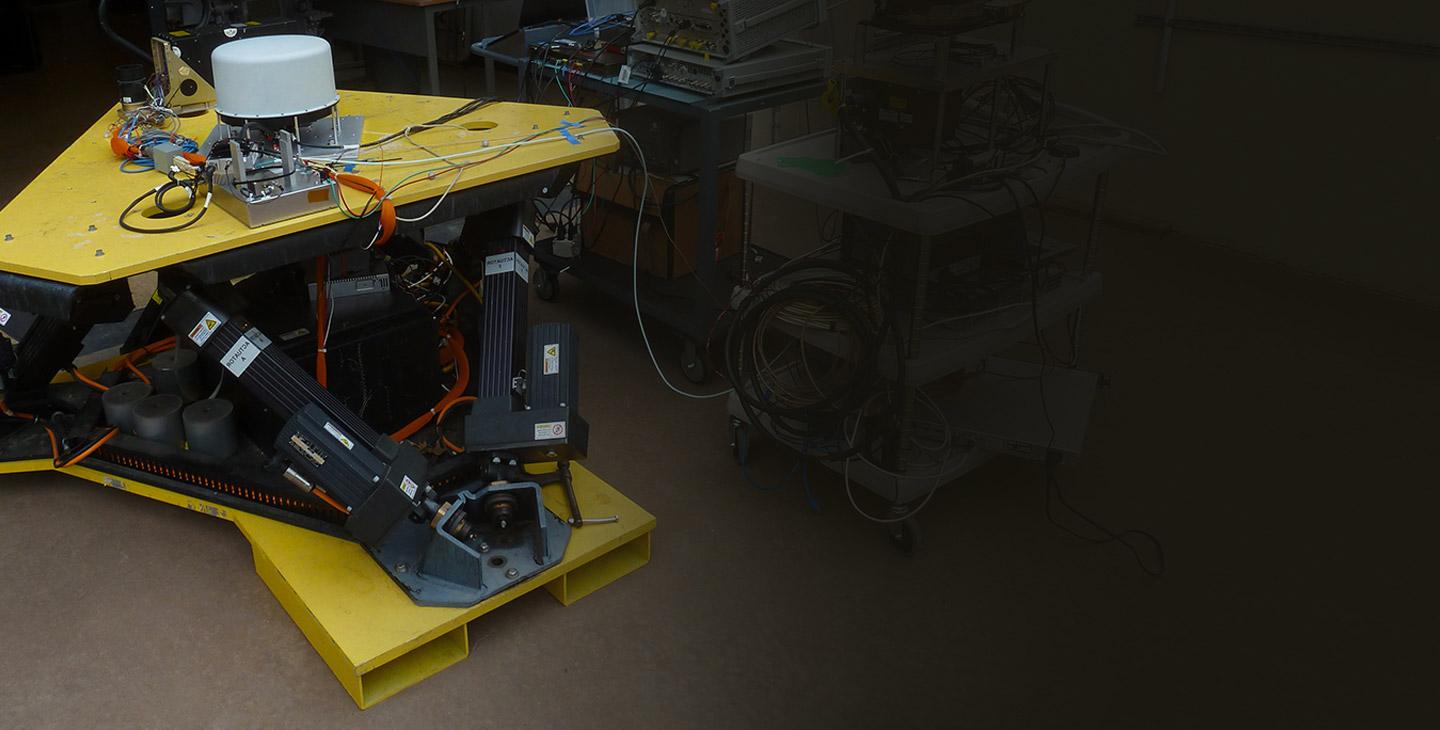 Antenna testing taking place inside a Viasat lab on an antenna component wtih yellow plates